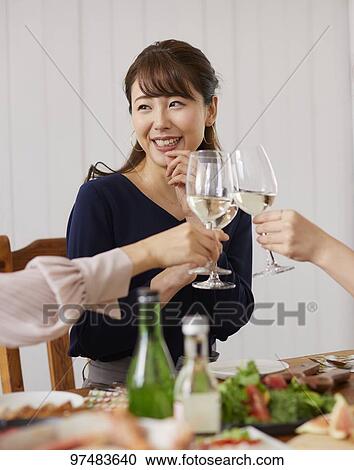 Stock Image - Japanese women having home party. Fotosearch