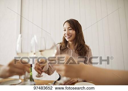 Stock Image - Japanese women having home party. Fotosearch