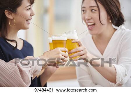 Stock Image - Japanese women having home party. Fotosearch