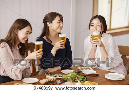 Stock Photo - Japanese women having home party. Fotosearch