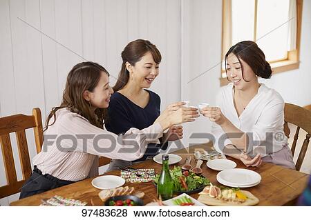 Stock Photo - Japanese women having home party. Fotosearch