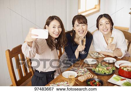 Stock Photo - Japanese women having home party. Fotosearch