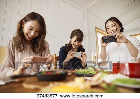 Japanese women having home party View Large Photo Image Stock Photo - Japanese women having home party. Fotosearch
