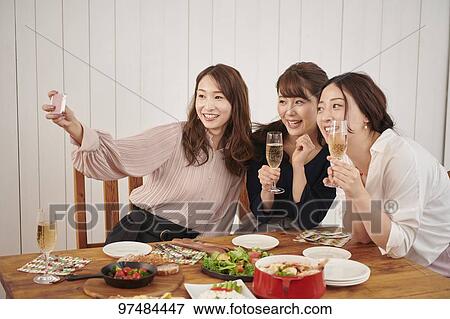Japanese women having home party View Large Photo Image Stock Photo - Japanese women having home party. Fotosearch