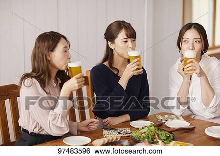 Stock Photograph - Japanese women having home party. Fotosearch