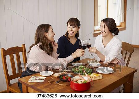 Stock Photograph - Japanese women having home party. Fotosearch