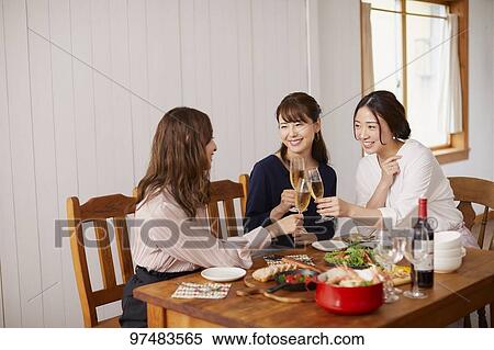 Stock Photography - Japanese women having home party. Fotosearch