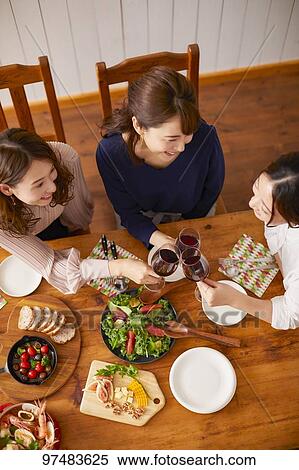 Stock Photography - Japanese women having home party. Fotosearch