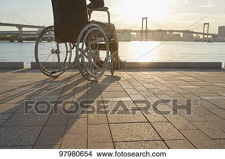 Picture - Japanese young man on wheelchair. Fotosearch