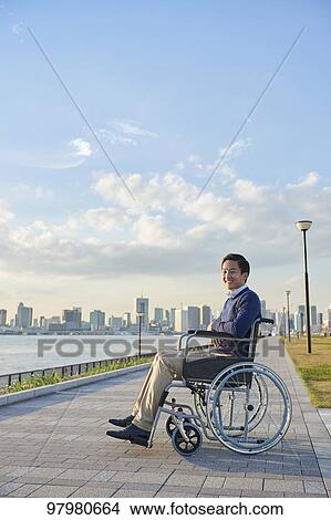 Picture - Japanese young man on wheelchair. Fotosearch