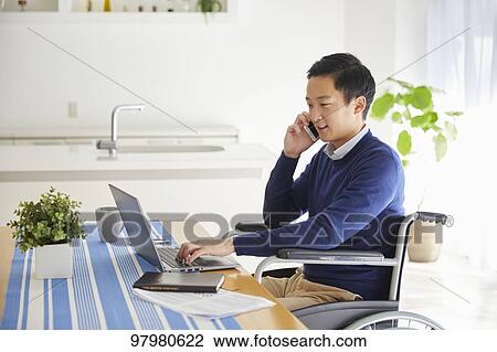 Japanese young man on wheelchair working from home View Large Photo Image Stock Image - Japanese young man on wheelchair working from home. Fotosearch