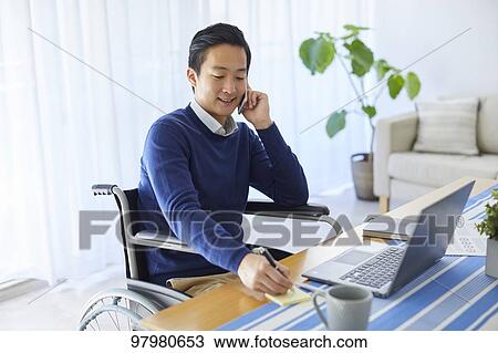 Japanese young man on wheelchair working from home View Large Photo Image Stock Image - Japanese young man on wheelchair working from home. Fotosearch