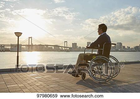 Stock Photo - Japanese young man on wheelchair. Fotosearch