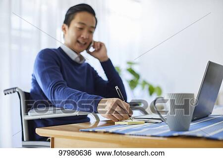 Japanese young man on wheelchair working from home View Large Photo Image Stock Photograph - Japanese young man on wheelchair working from home. Fotosearch