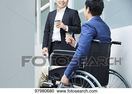 Japanese young man on wheelchair working View Large Photo Image Stock Image - Japanese young man on wheelchair working. Fotosearch