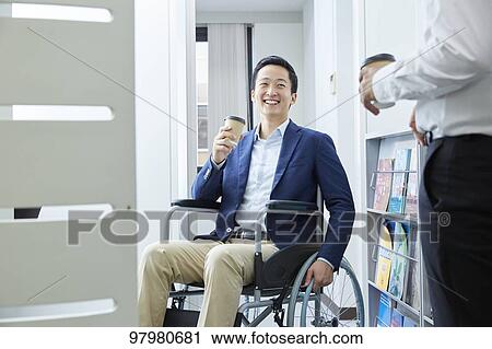 Japanese young man on wheelchair working View Large Photo Image Stock Image - Japanese young man on wheelchair working. Fotosearch