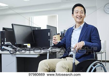 Japanese young man on wheelchair working View Large Photo Image Stock Photo - Japanese young man on wheelchair working. Fotosearch