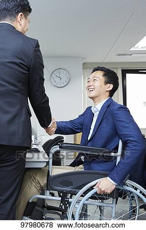 Japanese young man on wheelchair working View Large Photo Image Stock Photo - Japanese young man on wheelchair working. Fotosearch