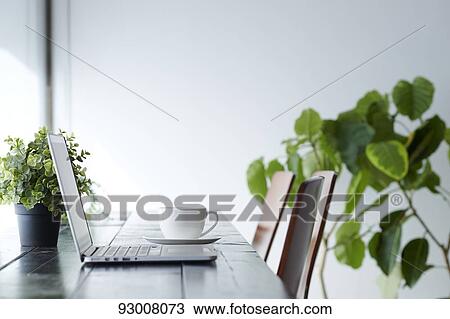 Stock Image - Laptop on wooden desk. Fotosearch