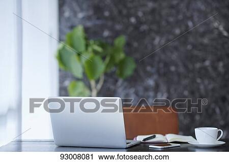 Laptop on wooden desk View Large Photo Image Stock Image - Laptop on wooden desk. Fotosearch