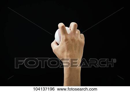 Stock Photograph - Male hand holding baseball ball. Fotosearch