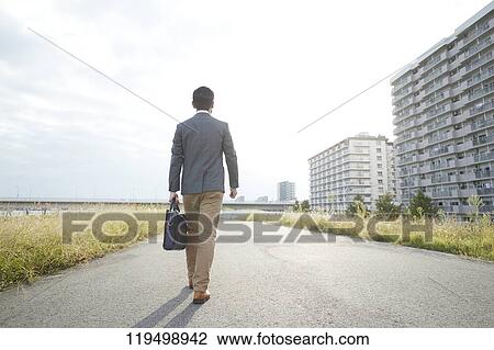 Stock Image - Mature Japanese man downtown Osaka, Japan. Fotosearch