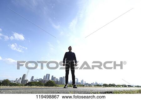 Stock Photo - Mature Japanese man downtown Osaka, Japan. Fotosearch