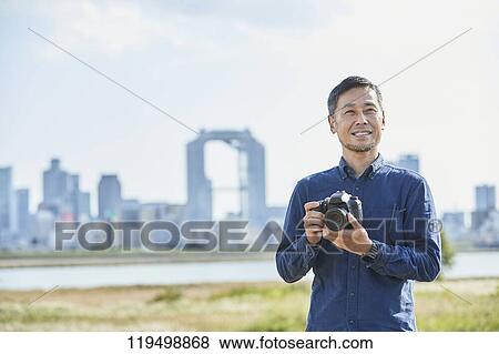Stock Photo - Mature Japanese man downtown Osaka, Japan. Fotosearch