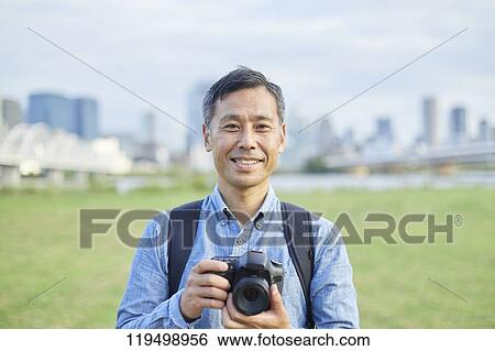 Stock Photograph - Mature Japanese man downtown Osaka, Japan. Fotosearch
