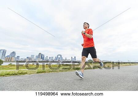 Mature Japanese man running downtown Osaka, Japan View Large Photo Image Picture - Mature Japanese man running downtown Osaka, Japan. Fotosearch