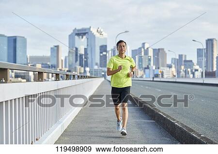 Mature Japanese man running downtown Osaka, Japan View Large Photo Image Stock Photo - Mature Japanese man running downtown Osaka, Japan. Fotosearch