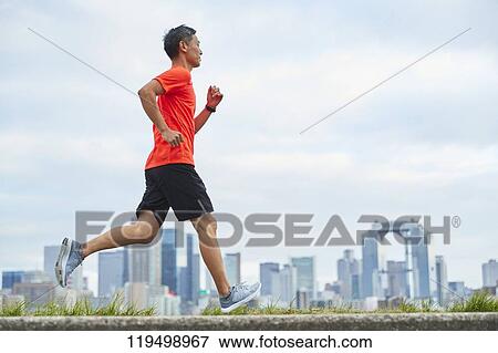 Mature Japanese man running downtown Osaka, Japan View Large Photo Image Stock Photo - Mature Japanese man running downtown Osaka, Japan. Fotosearch