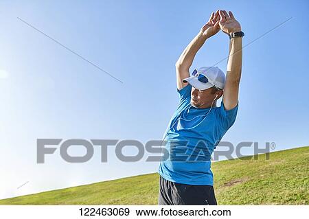 Stock Photo - Mature Japanese man training downtown. Fotosearch