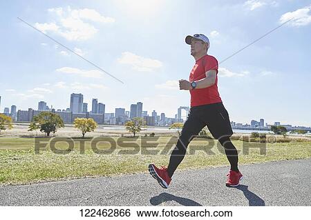 Stock Photograph - Mature Japanese man training downtown. Fotosearch