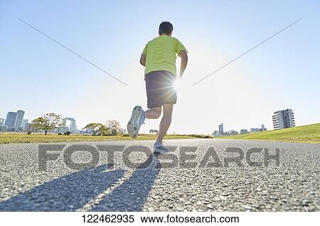 Stock Photography - Mature Japanese man training downtown. Fotosearch
