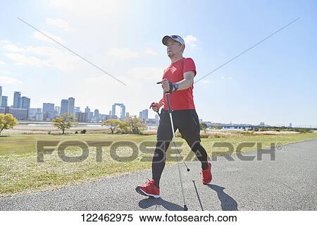 Stock Photography - Mature Japanese man training downtown. Fotosearch