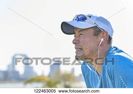 Stock Photography - Mature Japanese man training downtown. Fotosearch