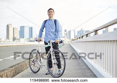 Mature Japanese man with bike downtown Osaka, Japan View Large Photo Image Stock Image - Mature Japanese man with bike downtown Osaka, Japan. Fotosearch