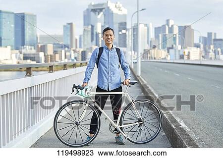 Mature Japanese man with bike downtown Osaka, Japan View Large Photo Image Stock Image - Mature Japanese man with bike downtown Osaka, Japan. Fotosearch