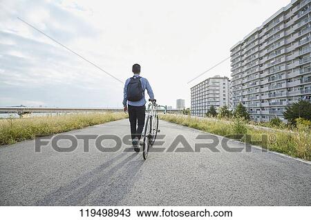 Mature Japanese man with bike downtown Osaka, Japan View Large Photo Image Stock Image - Mature Japanese man with bike downtown Osaka, Japan. Fotosearch