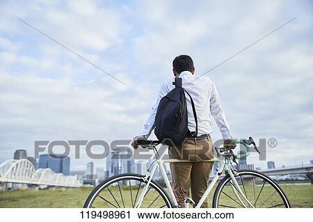 Mature Japanese man with bike downtown Osaka, Japan View Large Photo Image Stock Image - Mature Japanese man with bike downtown Osaka, Japan. Fotosearch