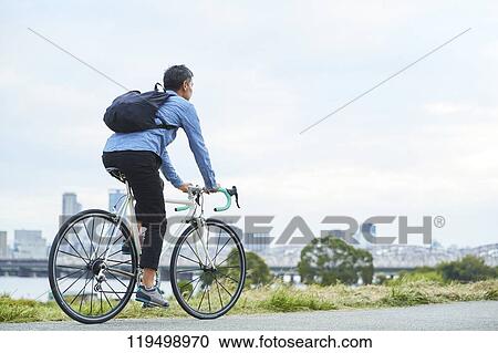 Mature Japanese man with bike downtown Osaka, Japan View Large Photo Image Stock Image - Mature Japanese man with bike downtown Osaka, Japan. Fotosearch