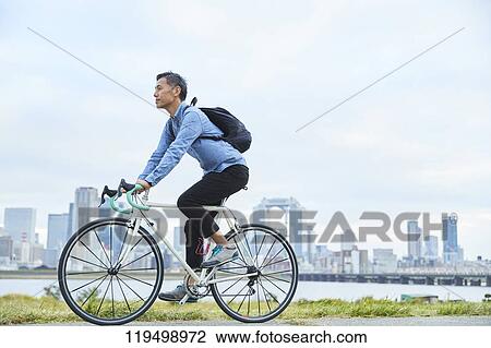 Mature Japanese man with bike downtown Osaka, Japan View Large Photo Image Stock Image - Mature Japanese man with bike downtown Osaka, Japan. Fotosearch