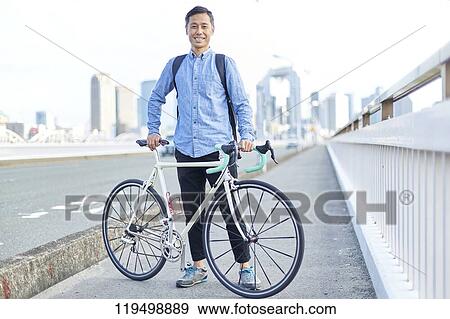 Mature Japanese man with bike downtown Osaka, Japan View Large Photo Image Stock Photo - Mature Japanese man with bike downtown Osaka, Japan. Fotosearch