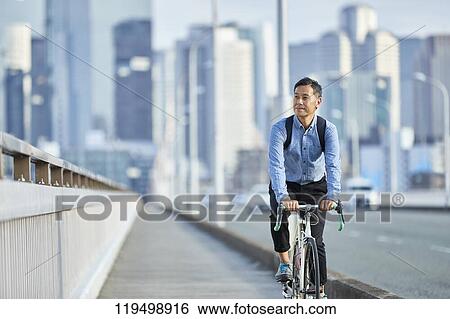 Mature Japanese man with bike downtown Osaka, Japan View Large Photo Image Stock Photograph - Mature Japanese man with bike downtown Osaka, Japan. Fotosearch