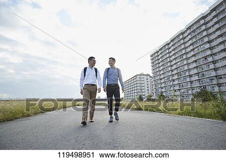 Stock Image - Mature Japanese men downtown Osaka, Japan. Fotosearch