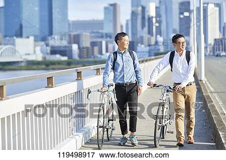 Mature Japanese men with bikes downtown Osaka, Japan View Large Photo Image Stock Photo - Mature Japanese men with bikes downtown Osaka, Japan. Fotosearch
