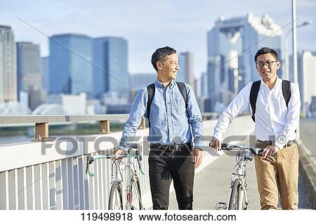 Mature Japanese men with bikes downtown Osaka, Japan View Large Photo Image Stock Photo - Mature Japanese men with bikes downtown Osaka, Japan. Fotosearch