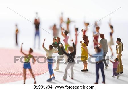 Miniature figures cheering View Large Photo Image Picture - Miniature figures cheering. Fotosearch