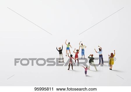 Stock Image - Miniature figures cheering. Fotosearch